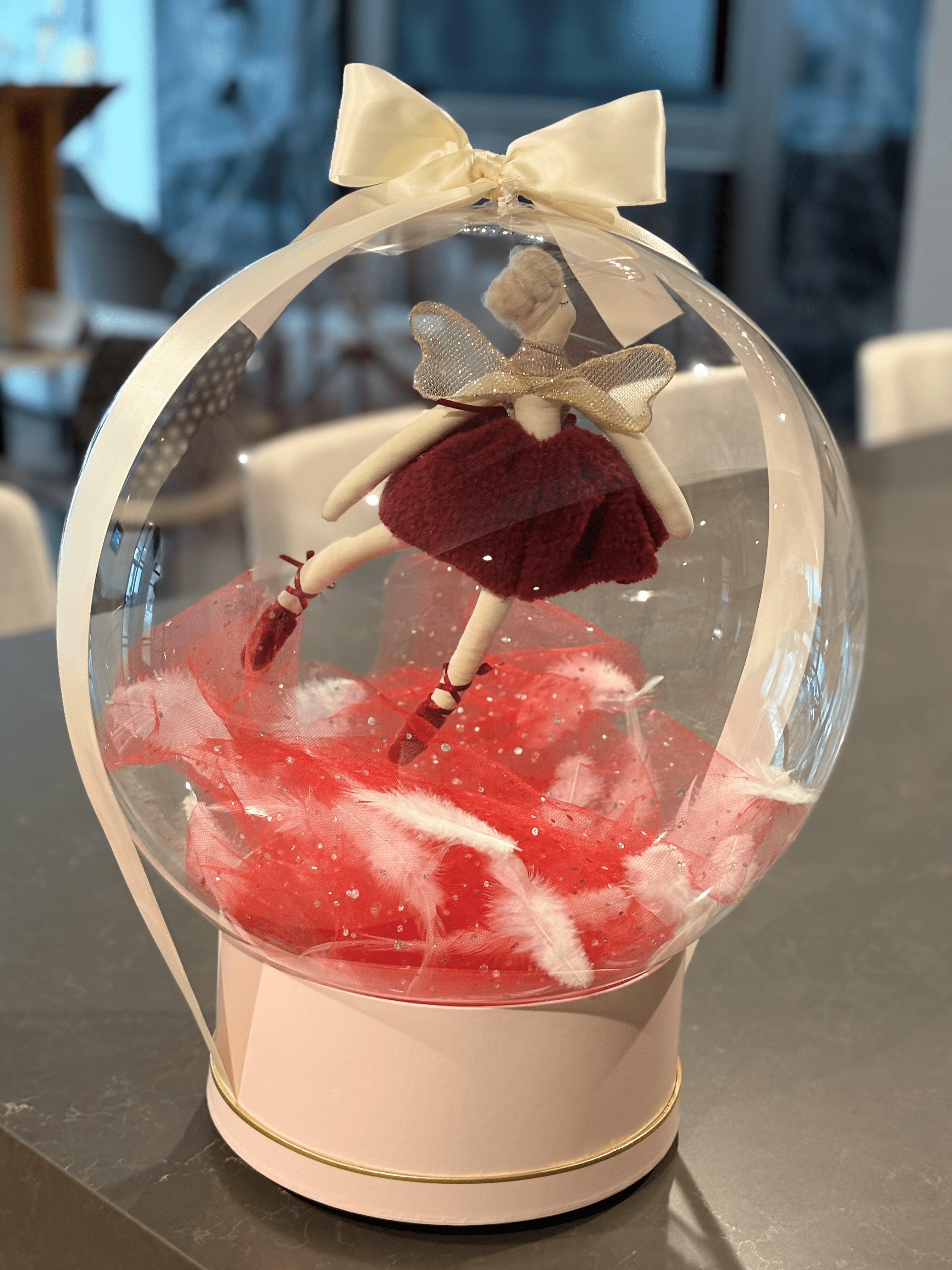 Blush ballerina balloon basket inside a clear globe